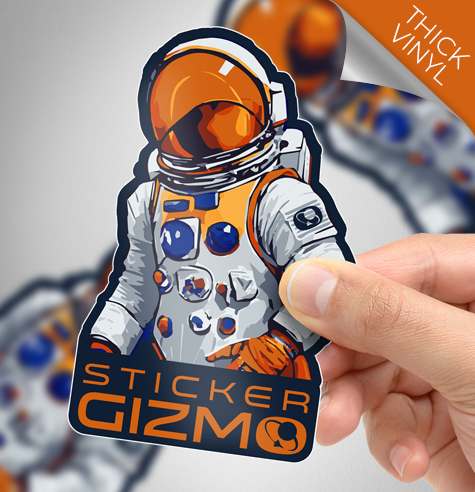 A hand holding a custom shape die cut sticker in the shape of a spaceman.